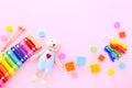 Colorful kids toys on pink background. Top view Royalty Free Stock Photo