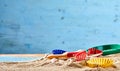 Colorful kids toys on a sandy beach Royalty Free Stock Photo