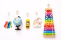 Colorful kids toys and wooden numbers in row on white background. Top view Royalty Free Stock Photo