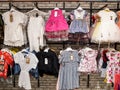 Colorful t-shirts on hangers hanging in row on hanger. Creative presentation of clothing for sale in store or on market