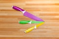 Colorful Kitchen Knives with Different Purposes on Top of a Wooden Cutting Board Royalty Free Stock Photo