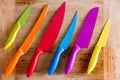 Colorful Kitchen Knives on Wooden Cutting Board Royalty Free Stock Photo