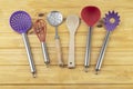 Colorful kitchen utensils over wooden table Royalty Free Stock Photo