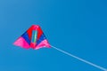 Colorful kite flying against blue sky background Royalty Free Stock Photo