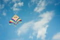 Colorful kite flying against the blue sky with clouds Royalty Free Stock Photo