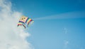 Colorful kite flying against the blue sky with clouds Royalty Free Stock Photo