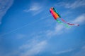 Colorful kite flying against a blue sky Royalty Free Stock Photo