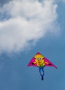 Colorful kite flying against blue sky with some cloud Royalty Free Stock Photo