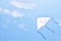 Colorful kite flying in the blue sky through the clouds Royalty Free Stock Photo