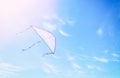 Colorful kite flying in the blue sky through the clouds Royalty Free Stock Photo