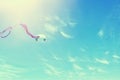 Colorful kite flying in the blue sky through the clouds Royalty Free Stock Photo