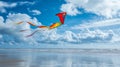Colorful Kite Flying Over a Sandy Beach Under a Bright Blue Sky Royalty Free Stock Photo