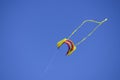 Colorful kite flying in the wind against the blue sky Royalty Free Stock Photo