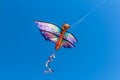 A colorful kite flying in the wind on a clear sunny day. Royalty Free Stock Photo