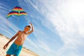 Colorful kite hold by boy on a beach over blue sky