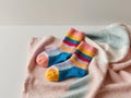 Colorful Knit Socks Resting on a Multicolored Blanket. Royalty Free Stock Photo