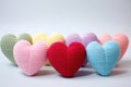 Colorful knitted hearts in pastel colors