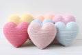 Colorful knitted hearts in pastel colors