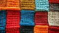Colorful knitted patchwork blanket showcasing vibrant textures and patterns in warm hues Royalty Free Stock Photo