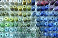 Colorful knitted thread spools put on a shelf at a shop