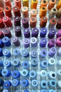 Colorful knitted thread spools put on a shelf at a shop