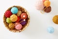 Colorful knitting yarn in a basket on white background