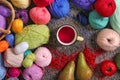 Colorful knitting yarn with metal cup of tea on carpet Royalty Free Stock Photo