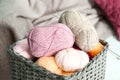 Colorful knitting yarn with needles in wicker basket indoors Royalty Free Stock Photo