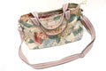 A colorful ladies sling bag with floral printings