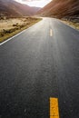 Colorful landscape with beautiful mountain road with a perfect asphalt. High rocks, blue sky at sunrise in summer Royalty Free Stock Photo