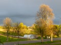 Colorful landscape with colorful trees in the evening light, a small village view of the street Royalty Free Stock Photo