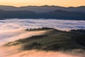 Stunning foggy mountains landscape, meadow in the morning fog on background valley in fog and sunrise mountains, Stunning nature Royalty Free Stock Photo