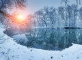 Colorful landscape with snowy trees, beautiful frozen river at