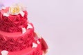 Colorful large red cake with white roses