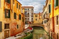 Colorful lateral canal and bridge in Venice, Italy