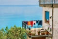 Colorful laundry drying outdoors with the sea in the background. Royalty Free Stock Photo