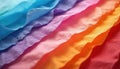 Colorful layers of crinkled tissue paper overlap creating abstract rainbow effect. Vibrant sheets offer texture for art projects. Royalty Free Stock Photo