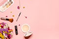 Colorful layout on a pink background with decorative cosmetics and dried flowers. Makeup products: beige powder, lipstick,