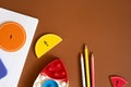 Colorful learning materials arranged on a brown surface for educational activities with shapes and numbers Royalty Free Stock Photo
