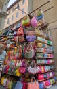 Colorful leather purses, handbags, wallets and handbags are displayed by street vendors at the outdoor Lorenzo Market at