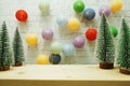 Colorful LED cotton ball and Christmas tree decorative on white brick wall background Royalty Free Stock Photo