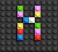 Colorful letter X from building lego bricks on black lego background. Lego letter M