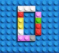 Colorful letters D of alphabet from building lego bricks on blue lego brick background. blue lego background. 3d letters C. Realis