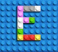 Colorful letters E of alphabet from building lego bricks on blue lego brick background. blue lego background. 3d letters C. Realis