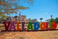 Colorful letters form the sign of Valladolid with a backdrop of Convent of San Bernardino de Siena. Valladolid, Yucatan, Mexico