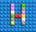 Colorful letters H of alphabet from building lego bricks on blue lego brick background. blue lego background. 3d letters C. Realis