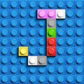 Colorful letters J of alphabet from building lego bricks on blue lego brick background. blue lego background. 3d letters C. Realis Royalty Free Stock Photo