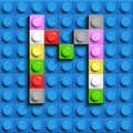 Colorful letters M of alphabet from building lego bricks on blue lego brick background. blue lego background. 3d letters C. Realis Royalty Free Stock Photo
