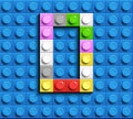 Colorful letters O of alphabet from building lego bricks on blue lego brick background. blue lego background. 3d letters C. Realis