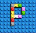 Colorful letters P of alphabet from building lego bricks on blue lego brick background. blue lego background. 3d letters C. Realis